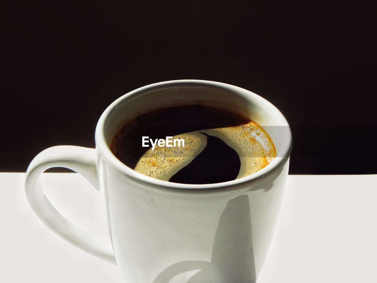 CLOSE-UP OF COFFEE CUP ON TABLE