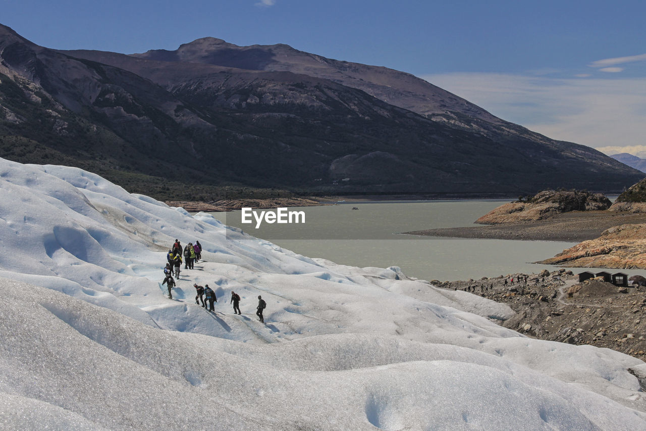 People climbing on snowcapped mountains