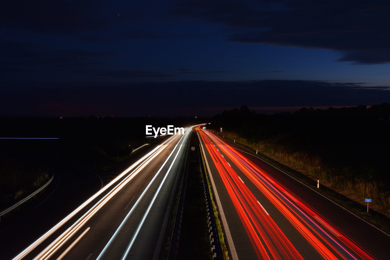 High angle view of light trails on road at night