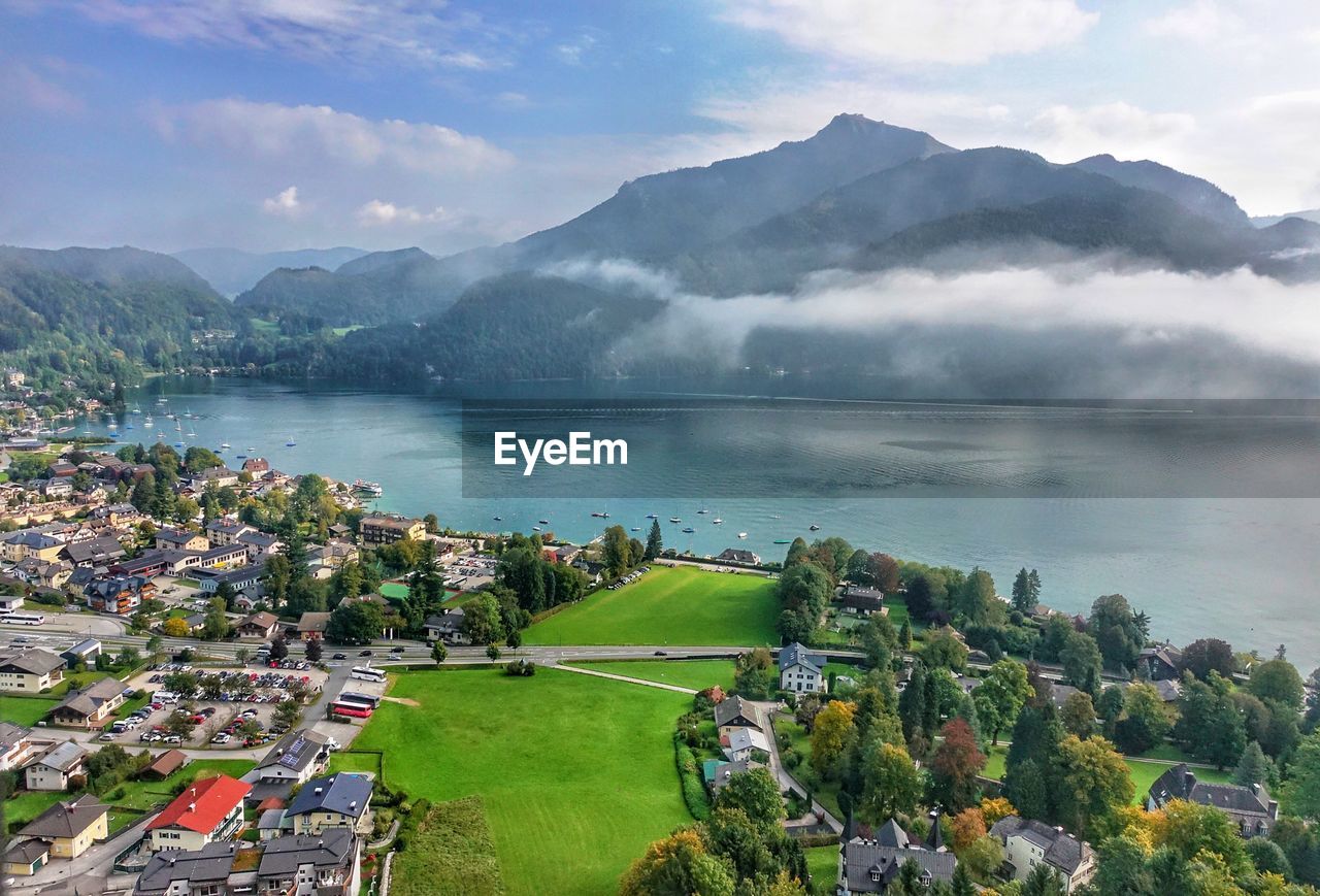 High angle view of lake and mountains against sky