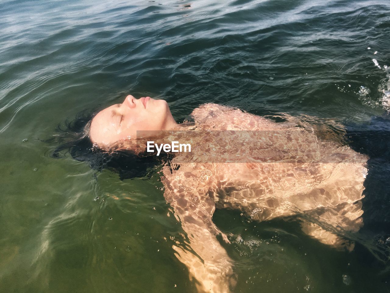 High angle view of young person swimming in sea