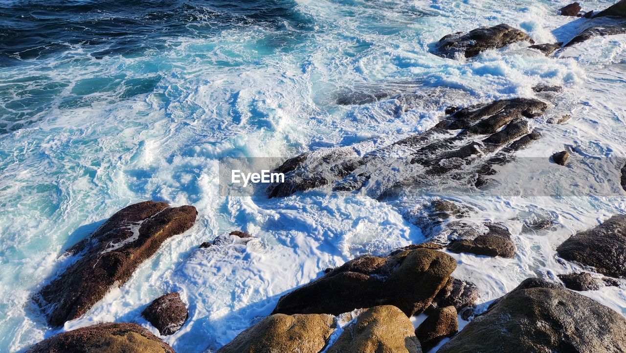 high angle view of rocks in sea