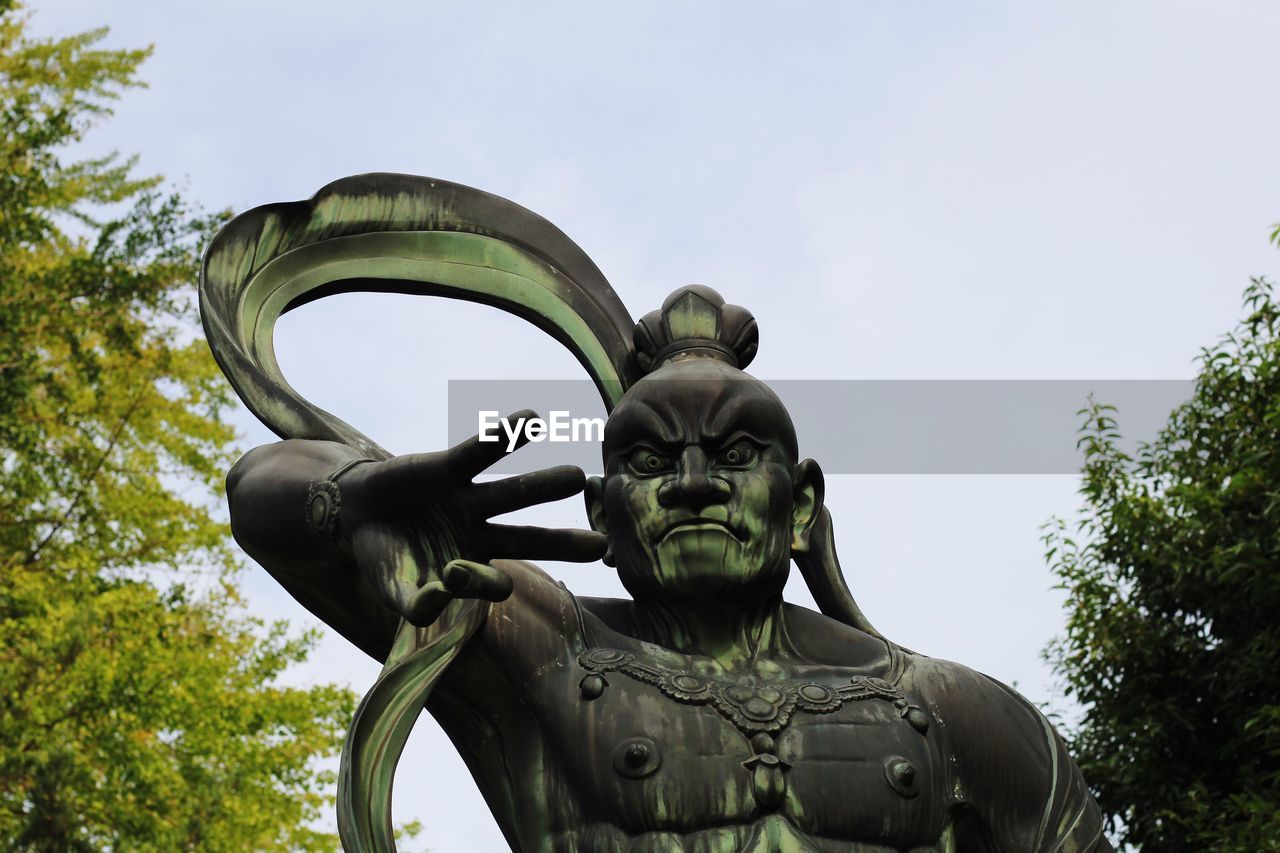 Low angle view of statue against sky