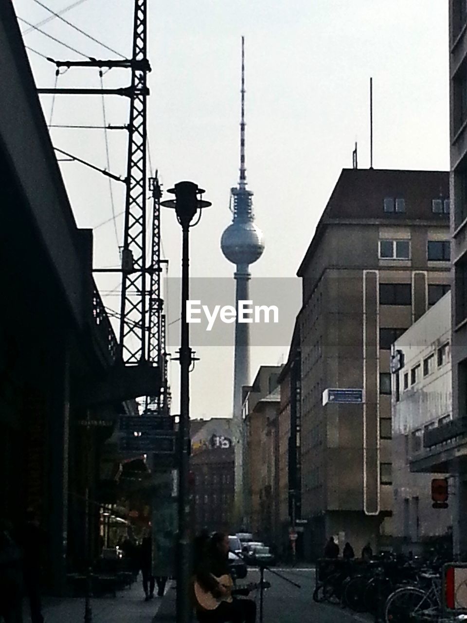 Low angle view of fernsehturm tower amidst buildings in city
