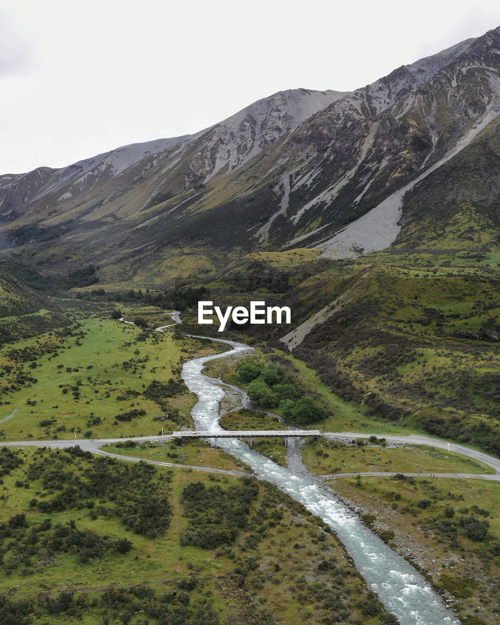 Scenic view of a river stream against the backdrop of mountains 