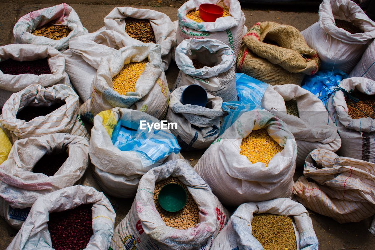 High angle view of various raw food in sack at market for sale