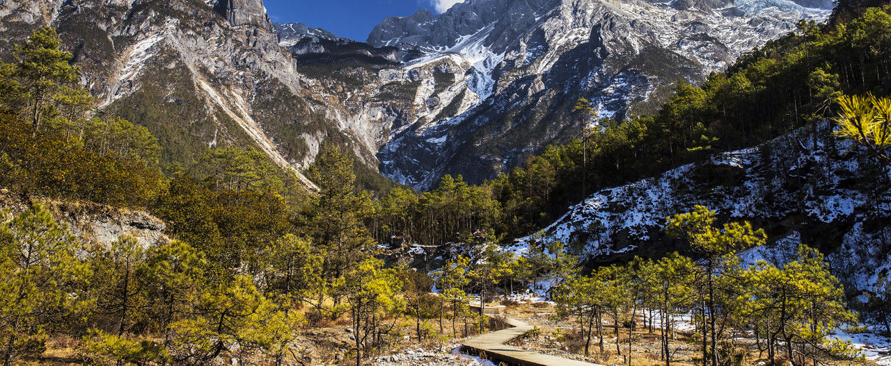 mountain, tree, plant, scenics - nature, beauty in nature, mountain range, snow, nature, wilderness, environment, cold temperature, landscape, autumn, winter, land, pine tree, pinaceae, coniferous tree, sky, no people, travel destinations, travel, architecture, forest, snowcapped mountain, outdoors, day, tranquility, pine woodland, tranquil scene, valley, non-urban scene, mountain peak, tourism, built structure, activity, rock, building, adventure, leisure activity, sunlight, growth