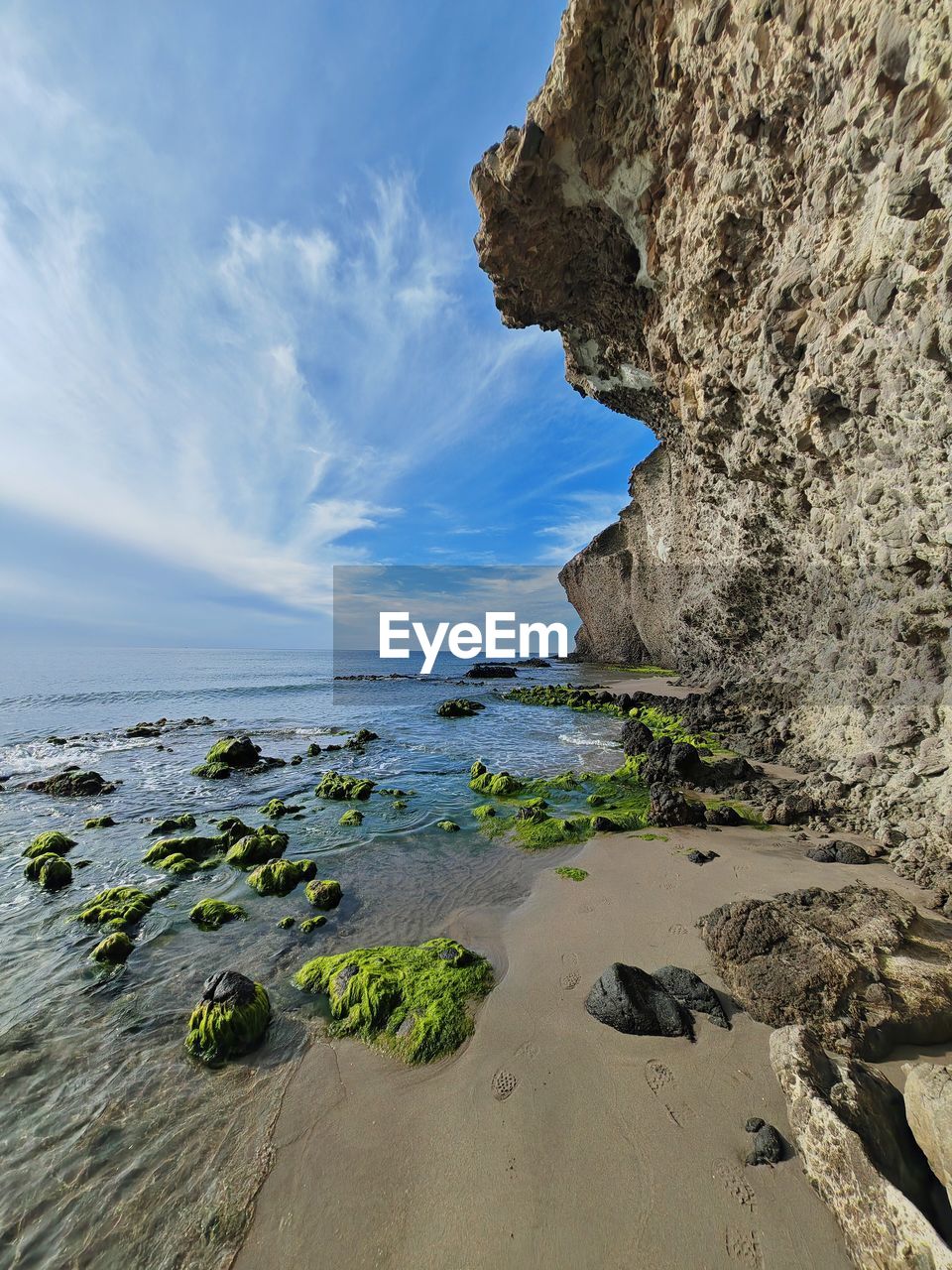 water, sea, rock, land, coast, sky, beach, nature, shore, scenics - nature, ocean, beauty in nature, cliff, terrain, tranquility, cloud, travel destinations, body of water, sand, environment, no people, travel, bay, landscape, coastline, rock formation, tranquil scene, outdoors, day, geology, blue, horizon over water, non-urban scene, wave, tourism, horizon, idyllic, plant, island, trip, seascape