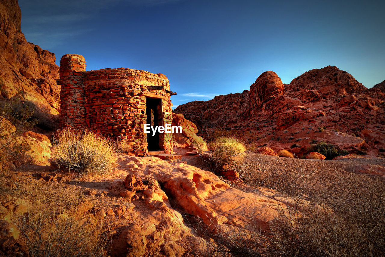 low angle view of rock formations against sky