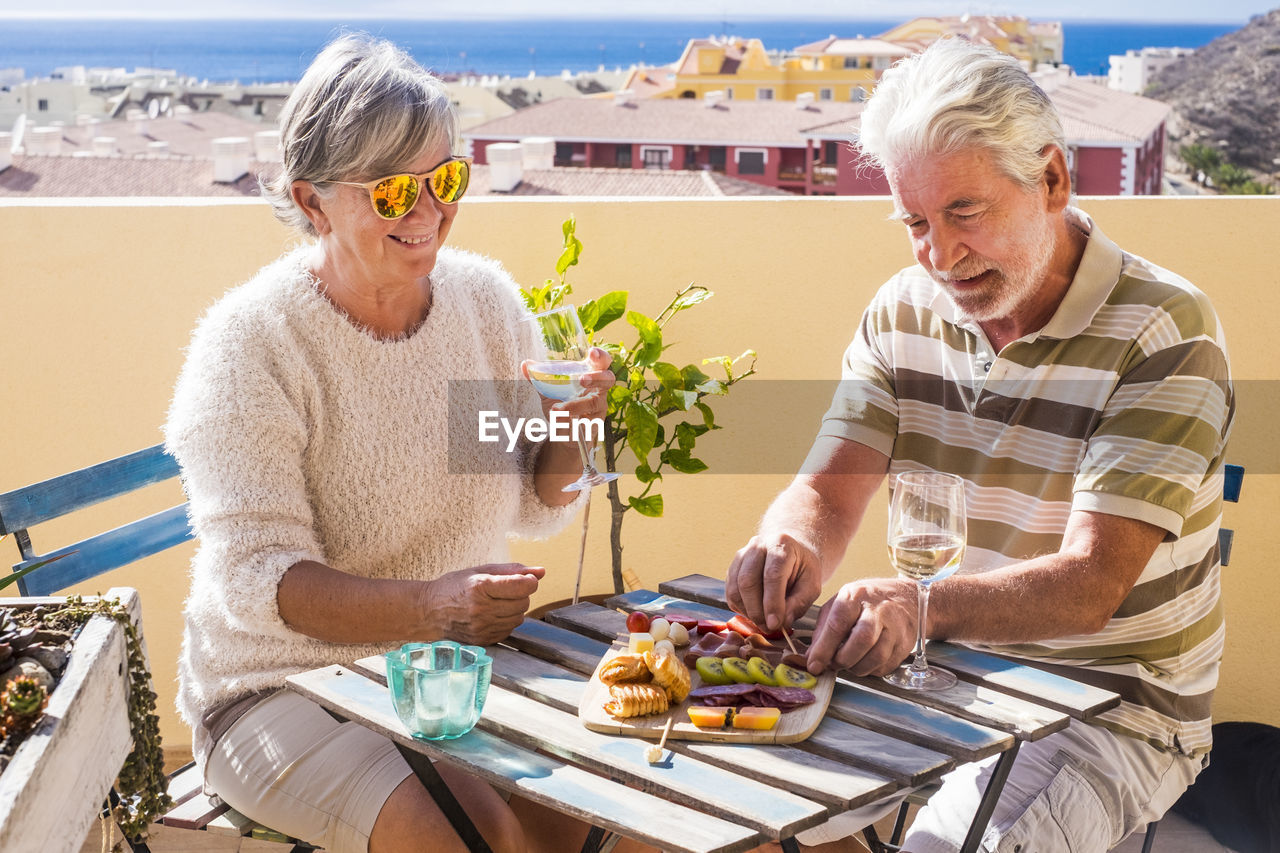 Senior couple enjoying wine at outdoors restaurant