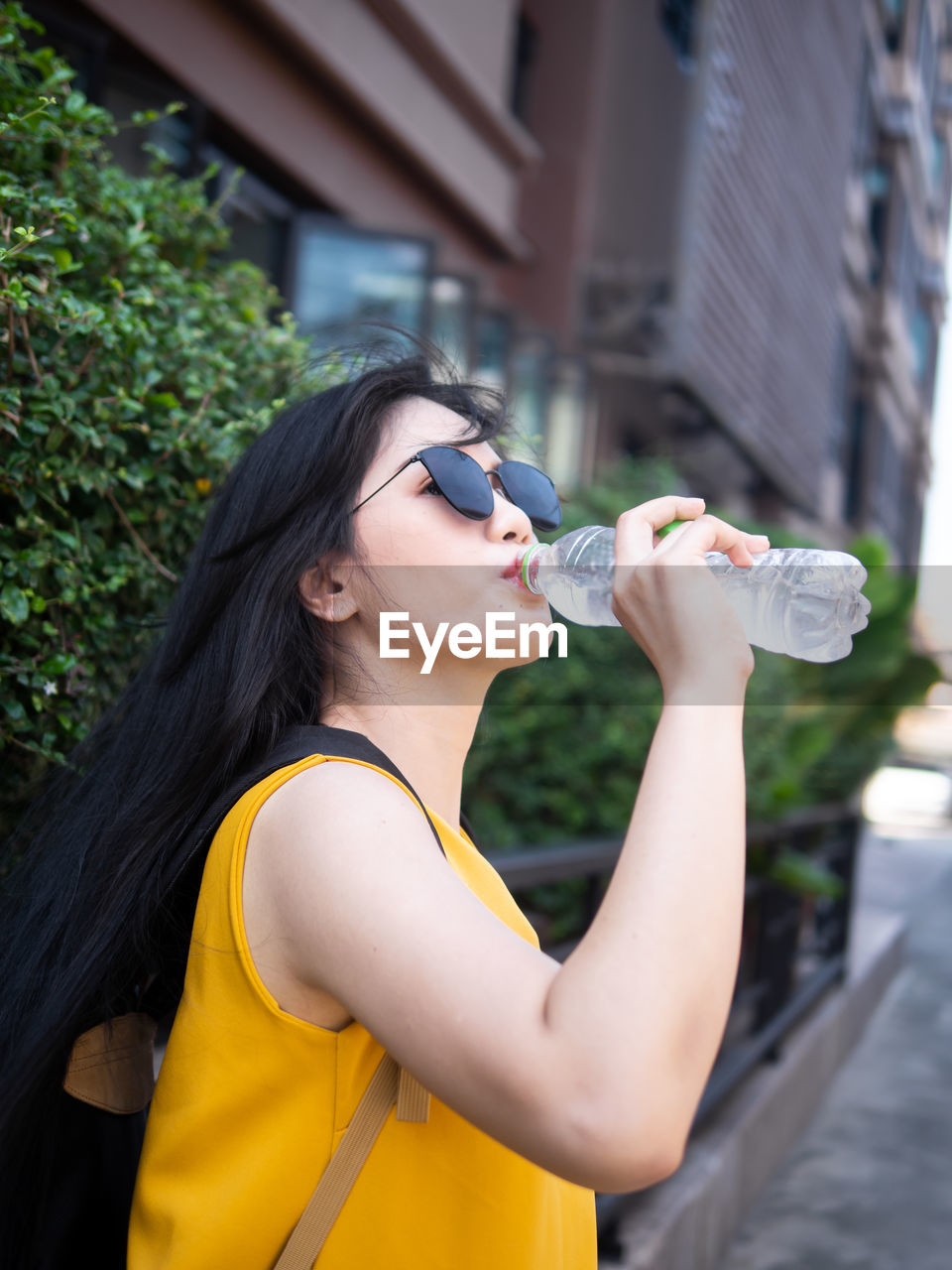 Young woman drinking water from bottle