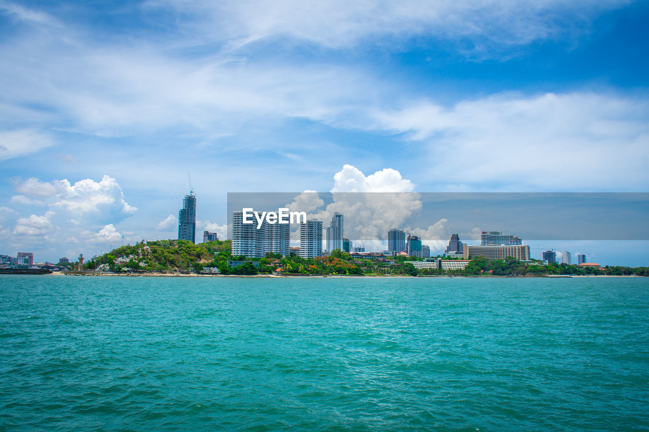 Scenic view of sea and buildings against sky