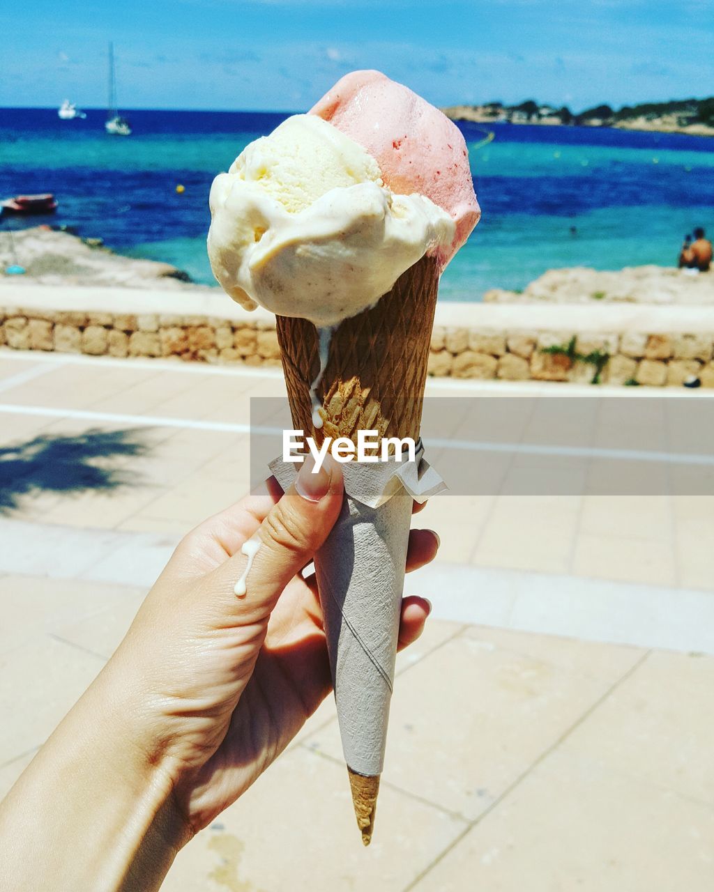 Cropped image of hand holding ice cream cone 