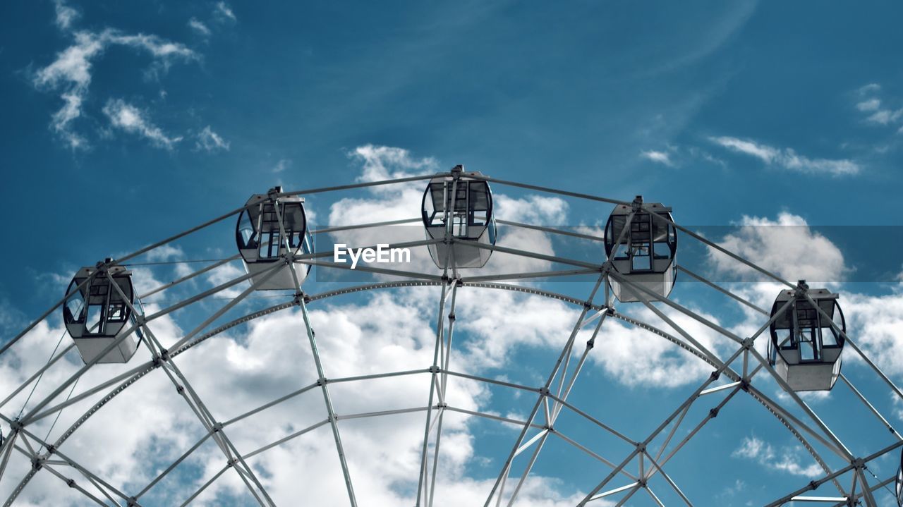 Low angle view of ferris wheel against sky