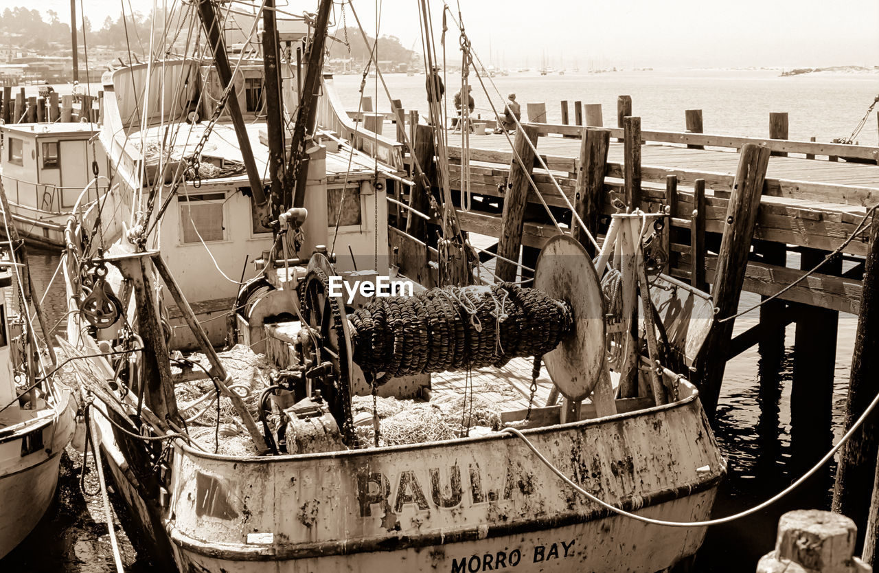 ABANDONED BOAT MOORED AT WATER