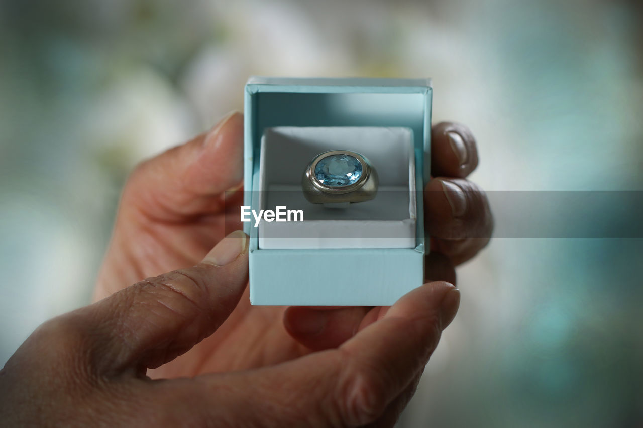 CLOSE-UP OF HAND HOLDING CAMERA WITH MOBILE PHONE
