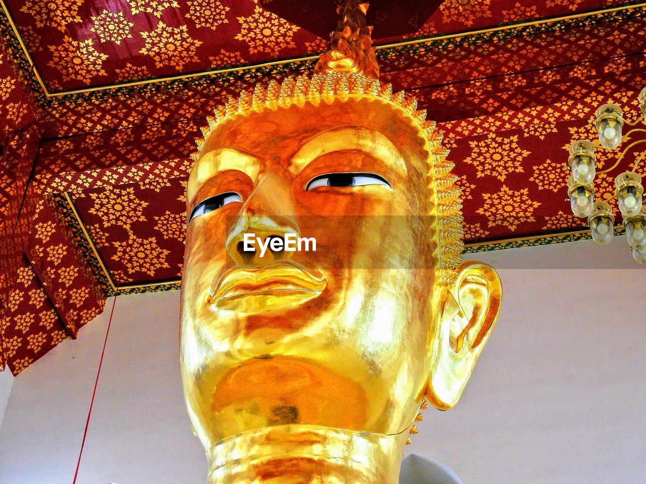 LOW ANGLE VIEW OF BUDDHA STATUE AT TEMPLE