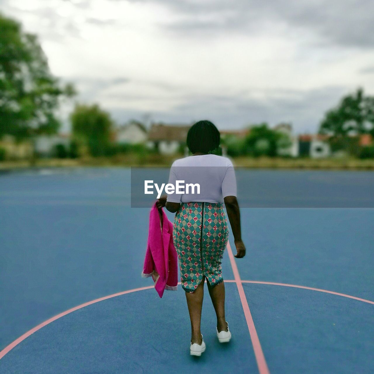 Rear view of woman standing on game court