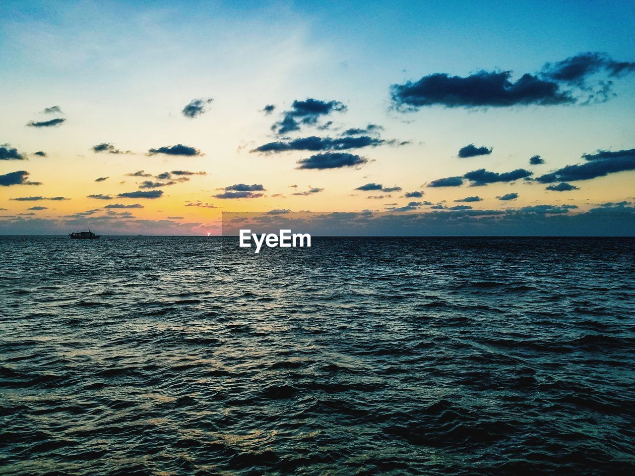 Scenic view of sea against sky at sunset