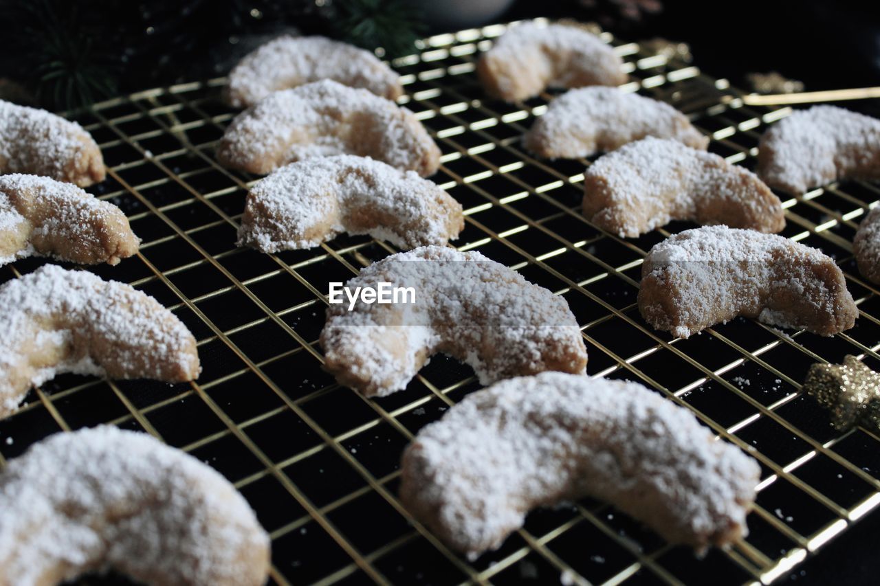 Handmade vanilla crescents on gold cooling grid