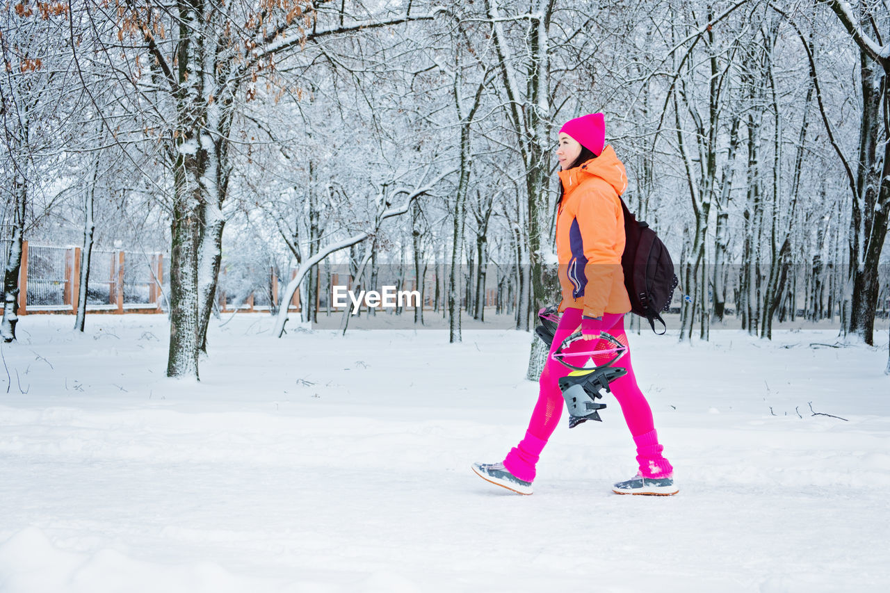Woman getting ready to winter workout outdoor exercise. winter fitness, exercising in cold weather