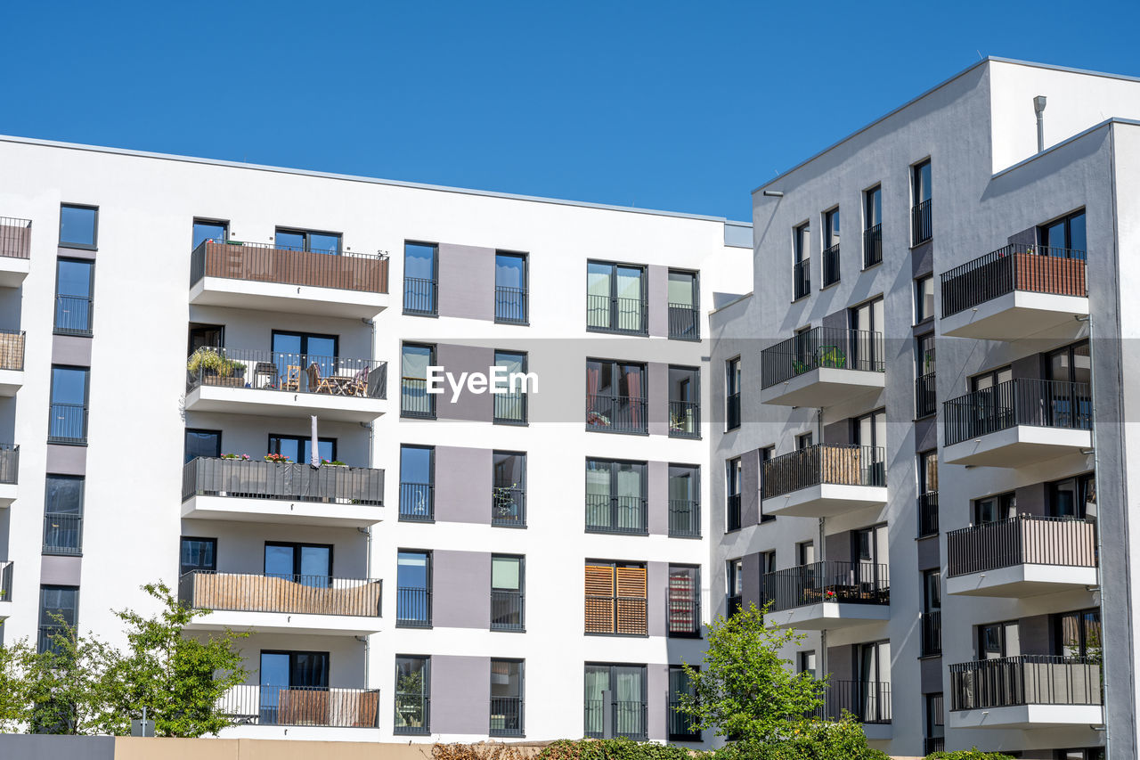 architecture, building exterior, built structure, condominium, building, tower block, commercial building, residential district, residential area, city, window, home ownership, apartment, neighbourhood, real estate, house, healthcare and medicine, facade, balcony, nature, headquarters, housing development, mixed-use, no people, office building exterior, industry, outdoors, construction industry, sky, housing project, community, business, development, large, dormitory, blue, planning, conformity, office, clear sky