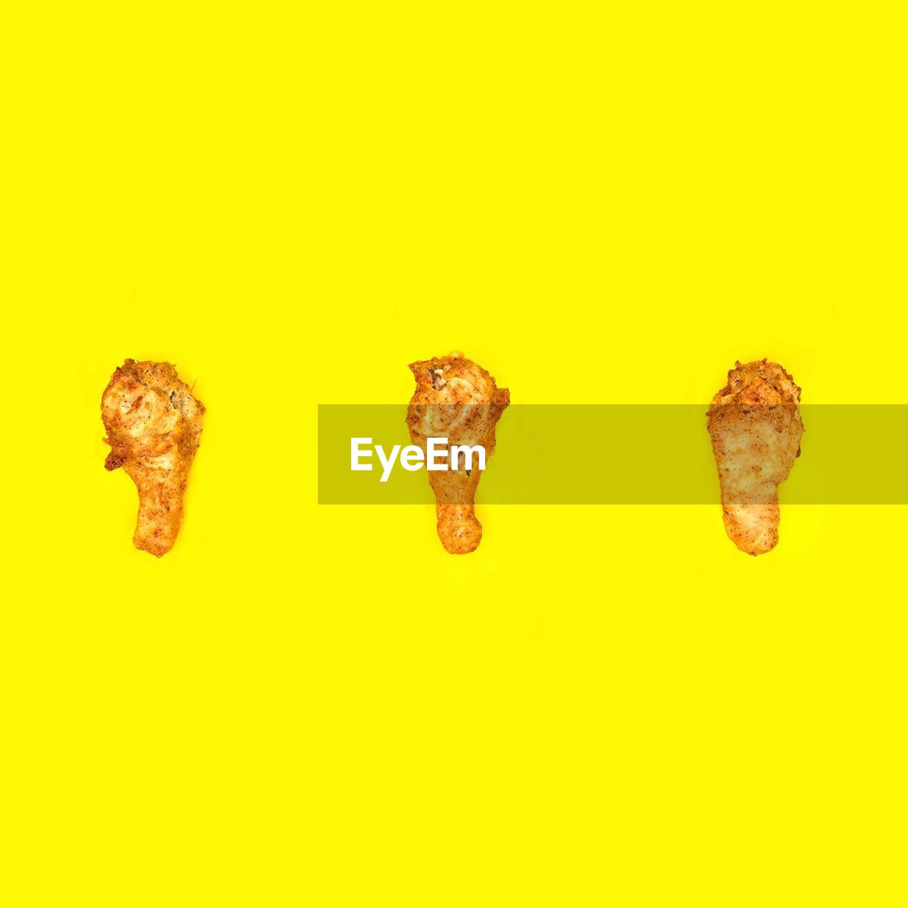 Close-up of fried chicken against yellow background