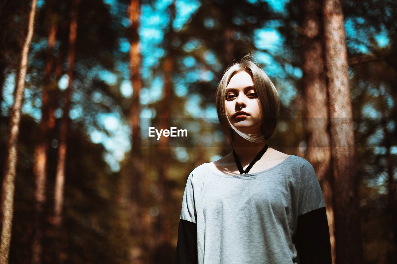 Portrait of beautiful young woman in forest