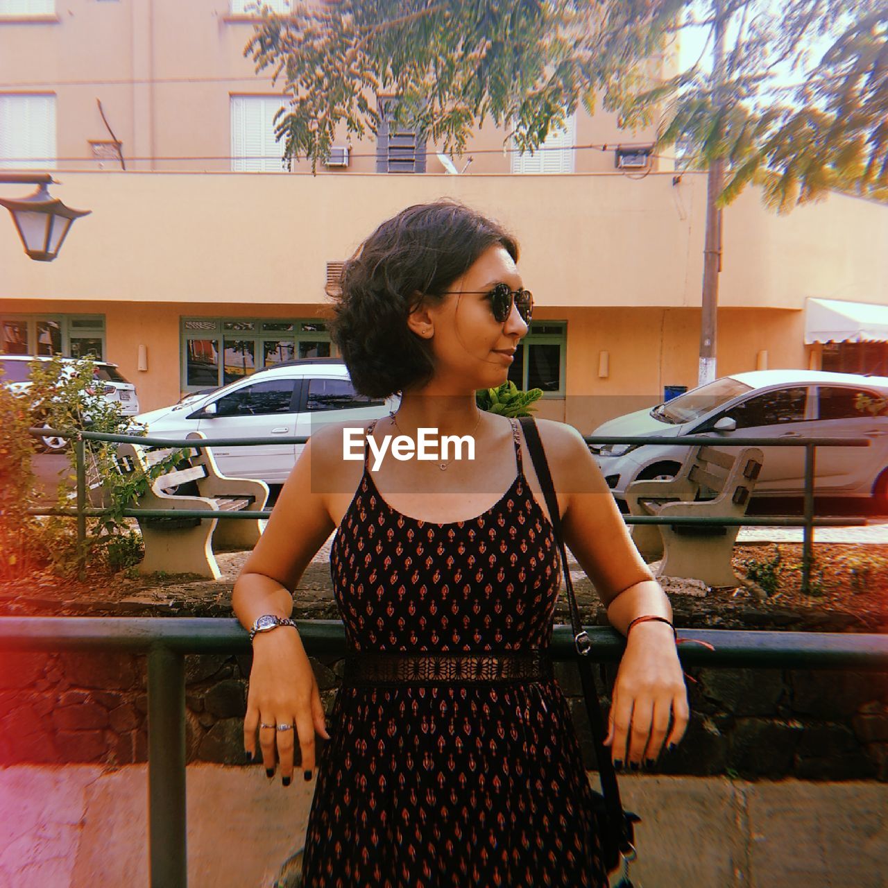 Young woman looking away while standing outdoors