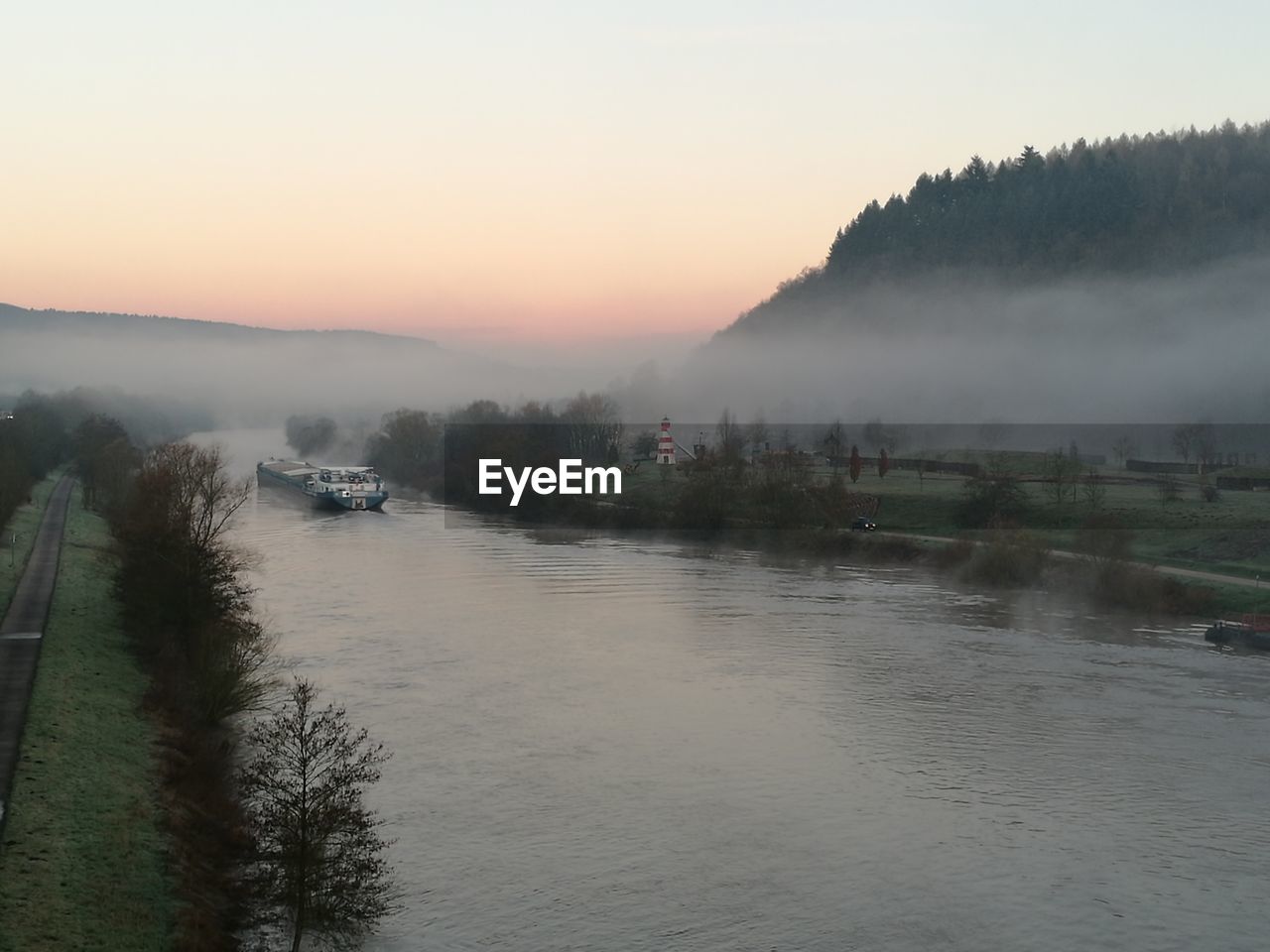 Scenic view of river against sky during sunset