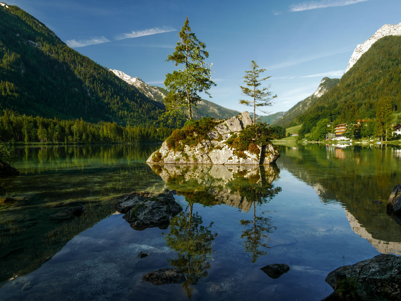 Scenic view of lake and mountains against sky