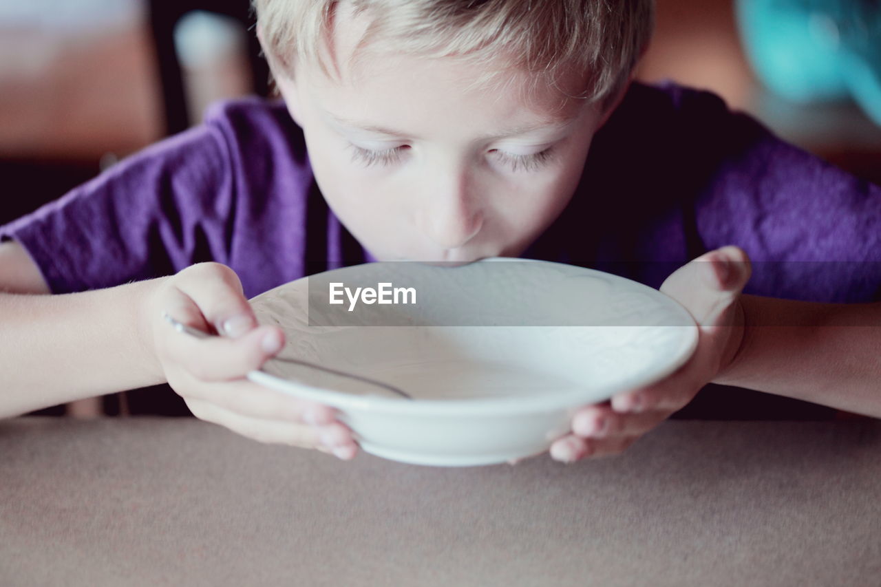 Close-up of boy finishing breakfast