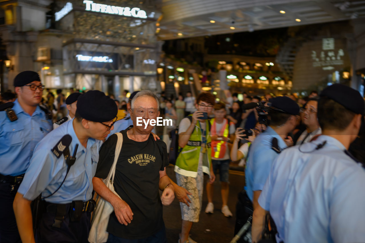 GROUP OF PEOPLE LOOKING AT MARKET