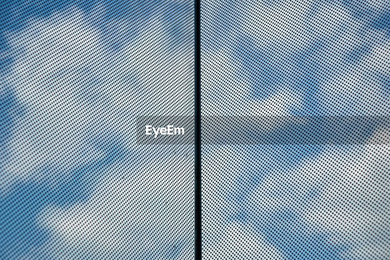 Directly below shot of cloudy sky seen through skylight