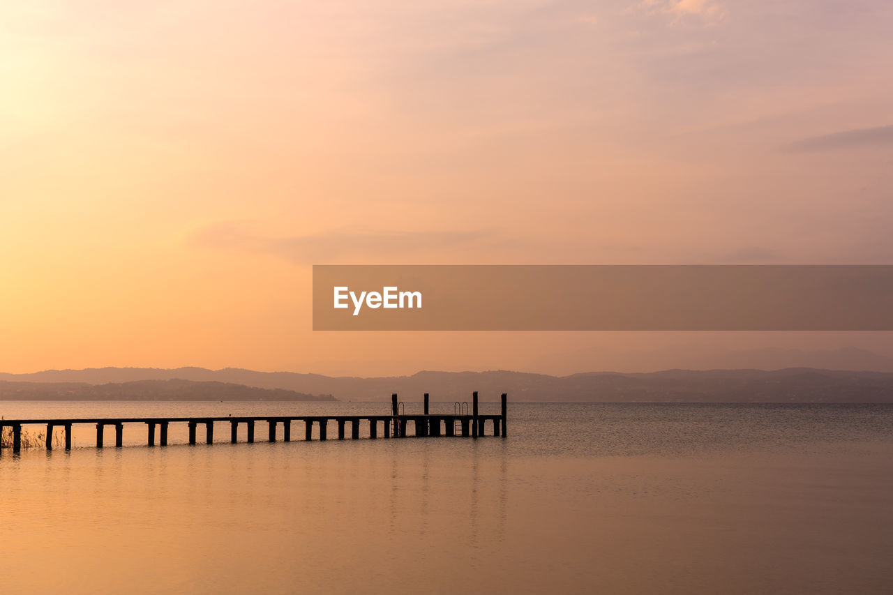 Silhouette pier on sea against sky during sunset