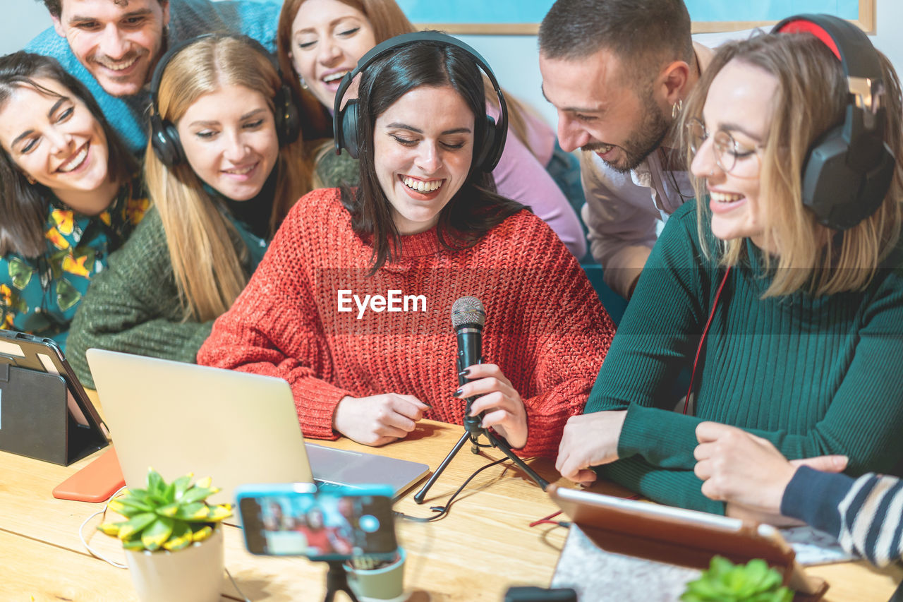 Coworkers filming video in creative office