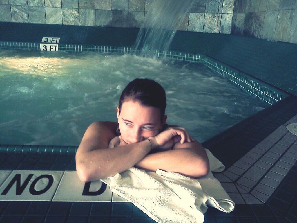 Young woman relaxing in spa pool