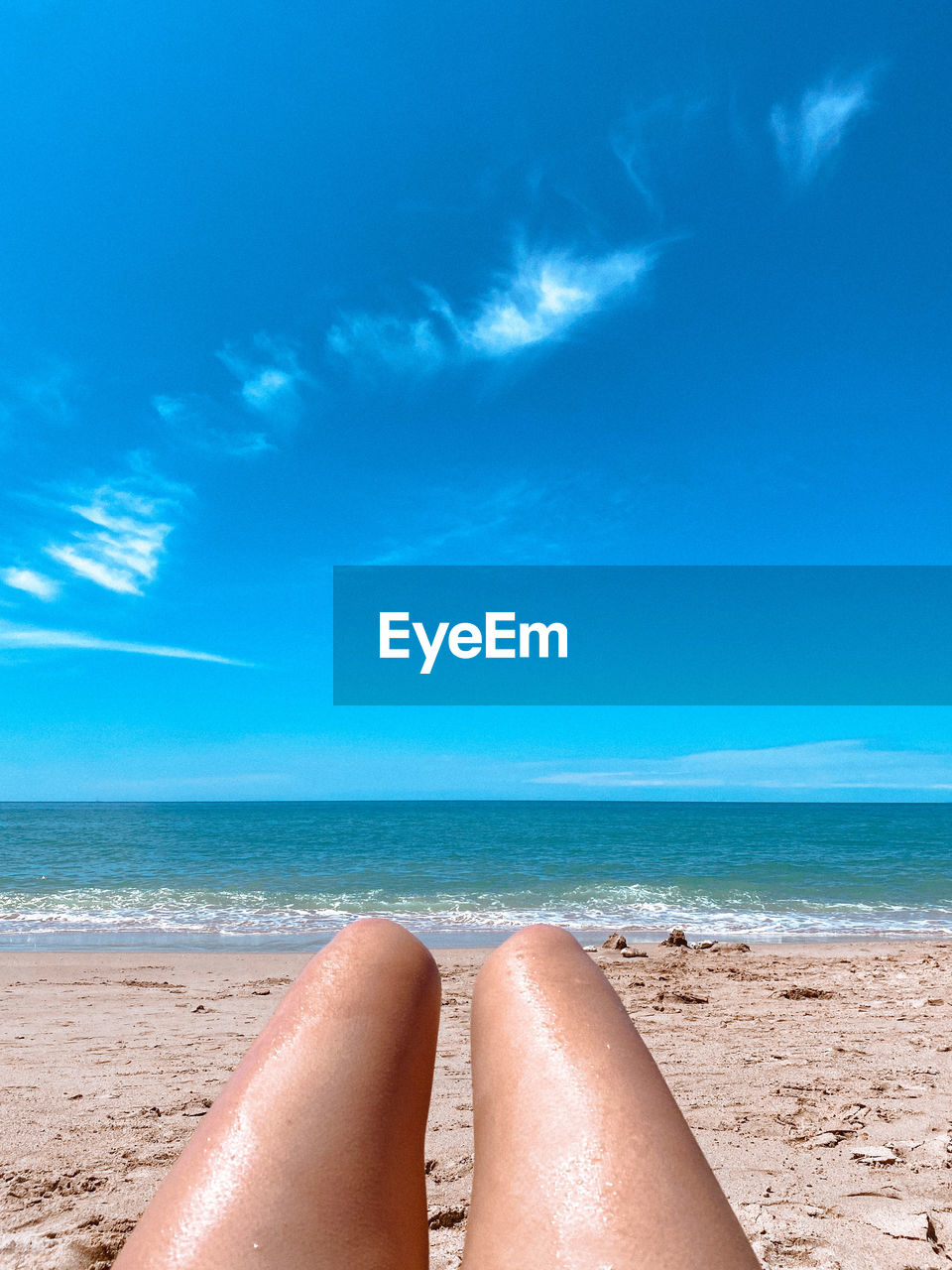 land, sea, beach, water, sky, human leg, sand, holiday, vacation, relaxation, trip, nature, low section, horizon over water, ocean, horizon, one person, blue, summer, adult, wave, beauty in nature, leisure activity, human foot, women, limb, scenics - nature, tranquility, shore, travel destinations, sunlight, travel, human limb, lifestyles, cloud, sun tanning, day, tranquil scene, body of water, personal perspective, outdoors, idyllic, sun, barefoot, sunbathing, tropical climate, copy space, lying down, azure, tourism, wind wave