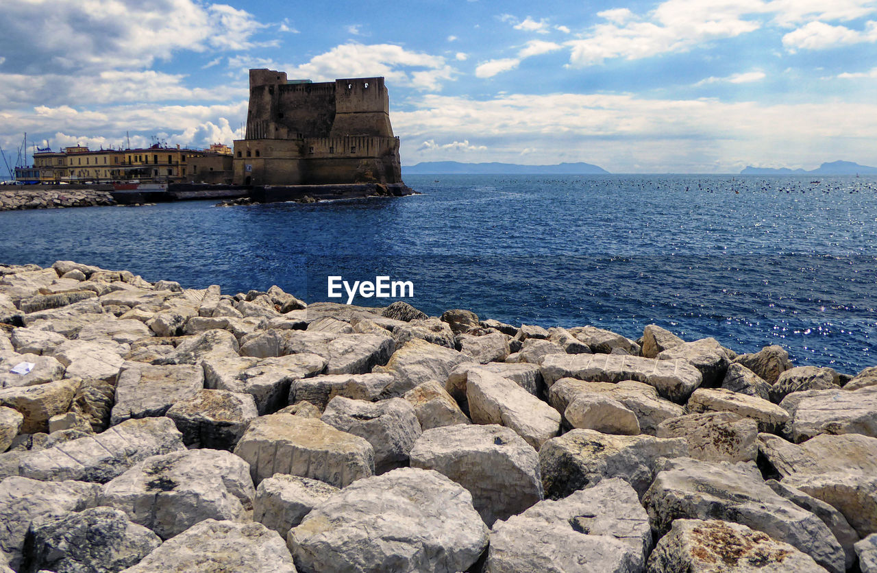 SCENIC VIEW OF ROCKS ON SEA AGAINST SKY