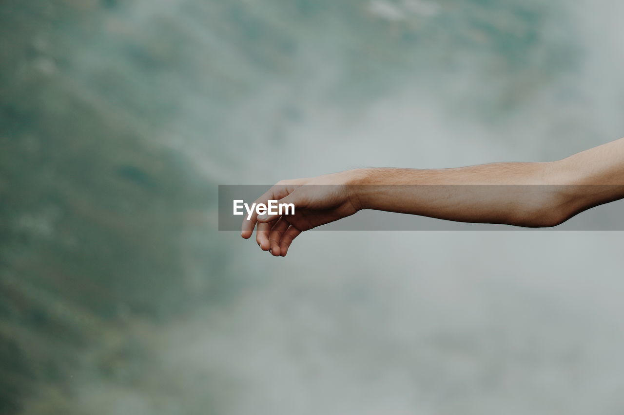 Close-up of person hand on mountain