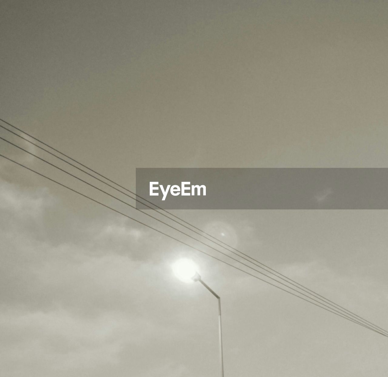 LOW ANGLE VIEW OF POWER LINE AGAINST SKY