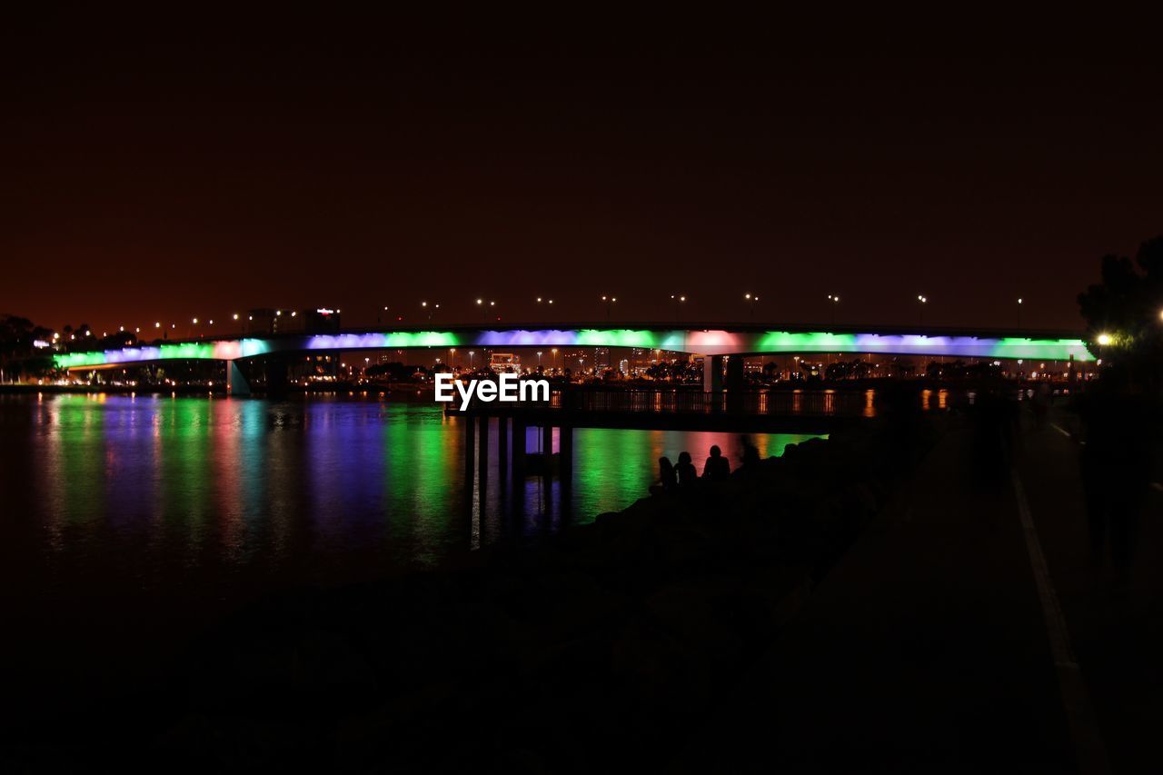 VIEW OF ILLUMINATED CITY AT NIGHT