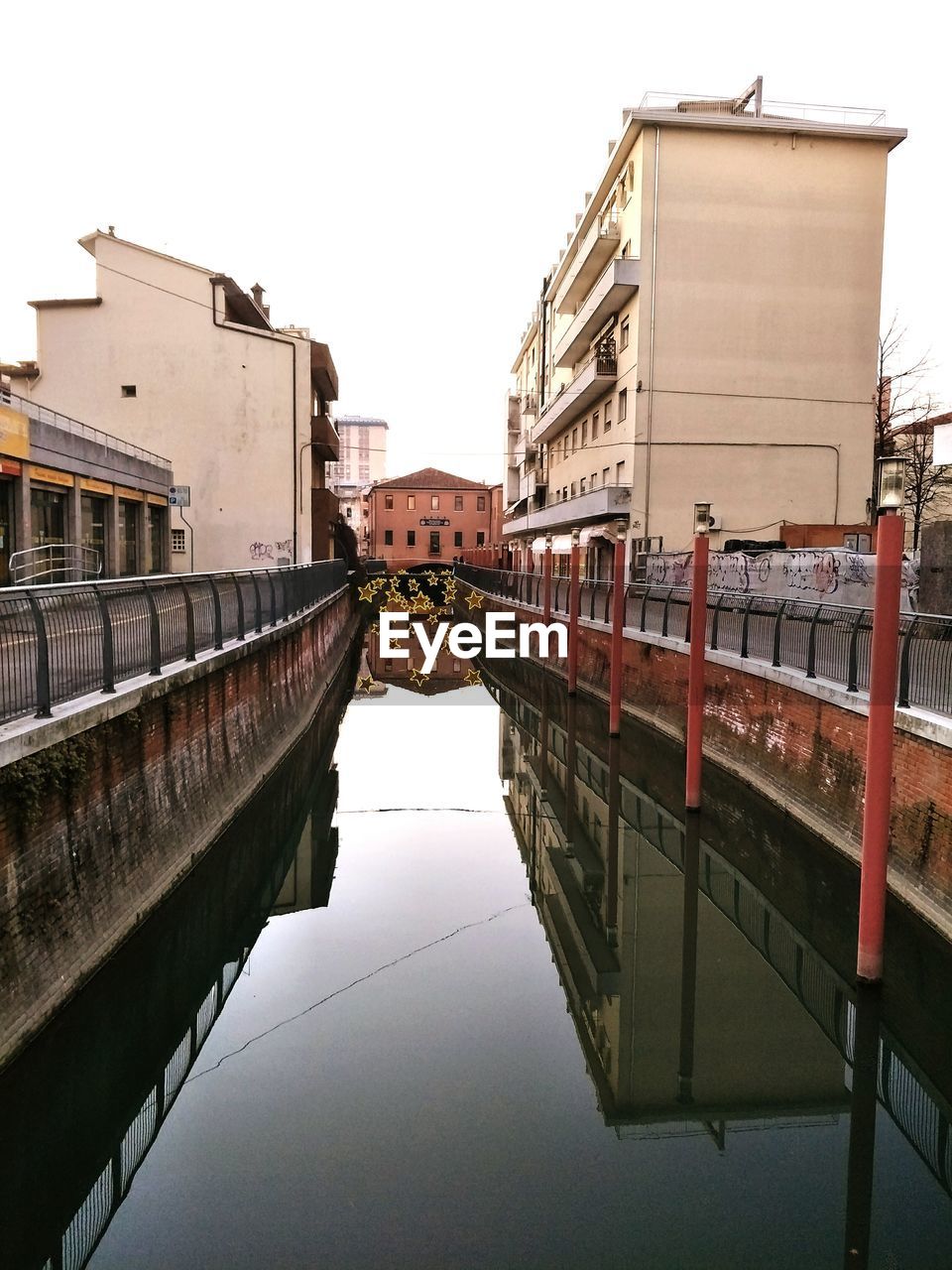 CANAL AMIDST BUILDINGS AGAINST CLEAR SKY