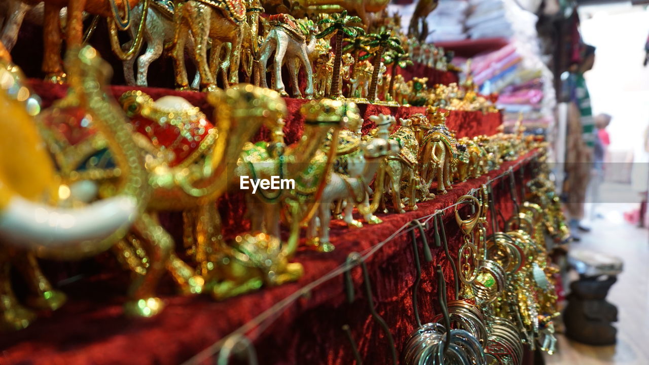 Golden camel figurines for sale in store