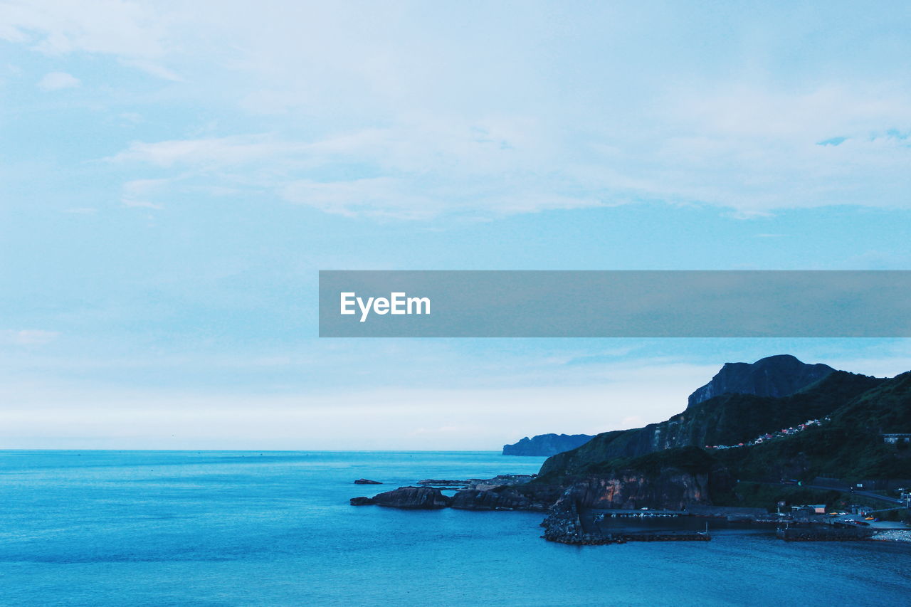 Scenic view of sea against blue sky