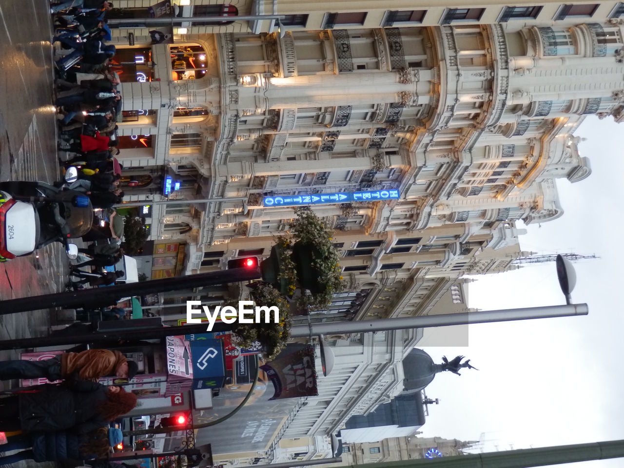 PEOPLE ON ROAD AGAINST BUILDINGS