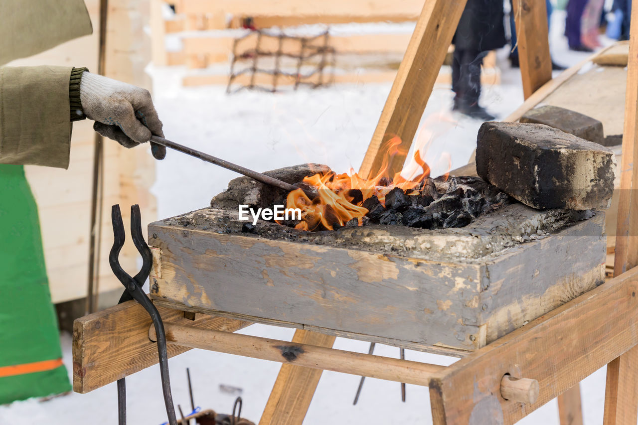 Cropped hand of blacksmith working in workshop