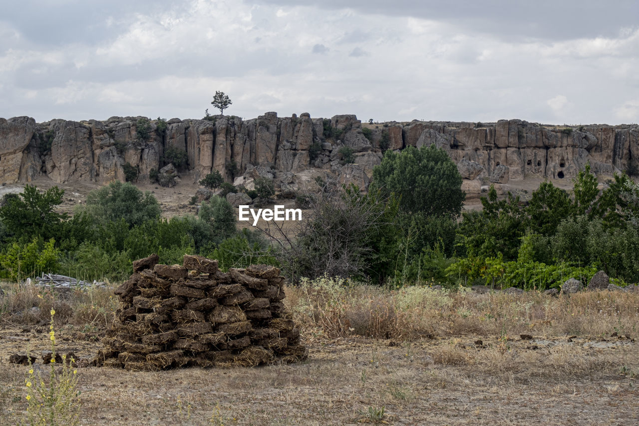 SCENIC VIEW OF ROCKS ON LANDSCAPE AGAINST SKY