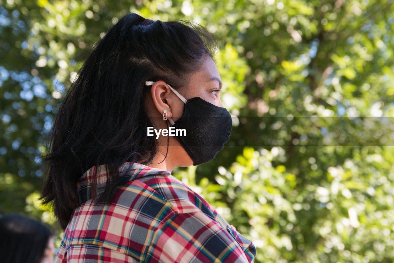 Portrait of young woman wearing face mask outdoors