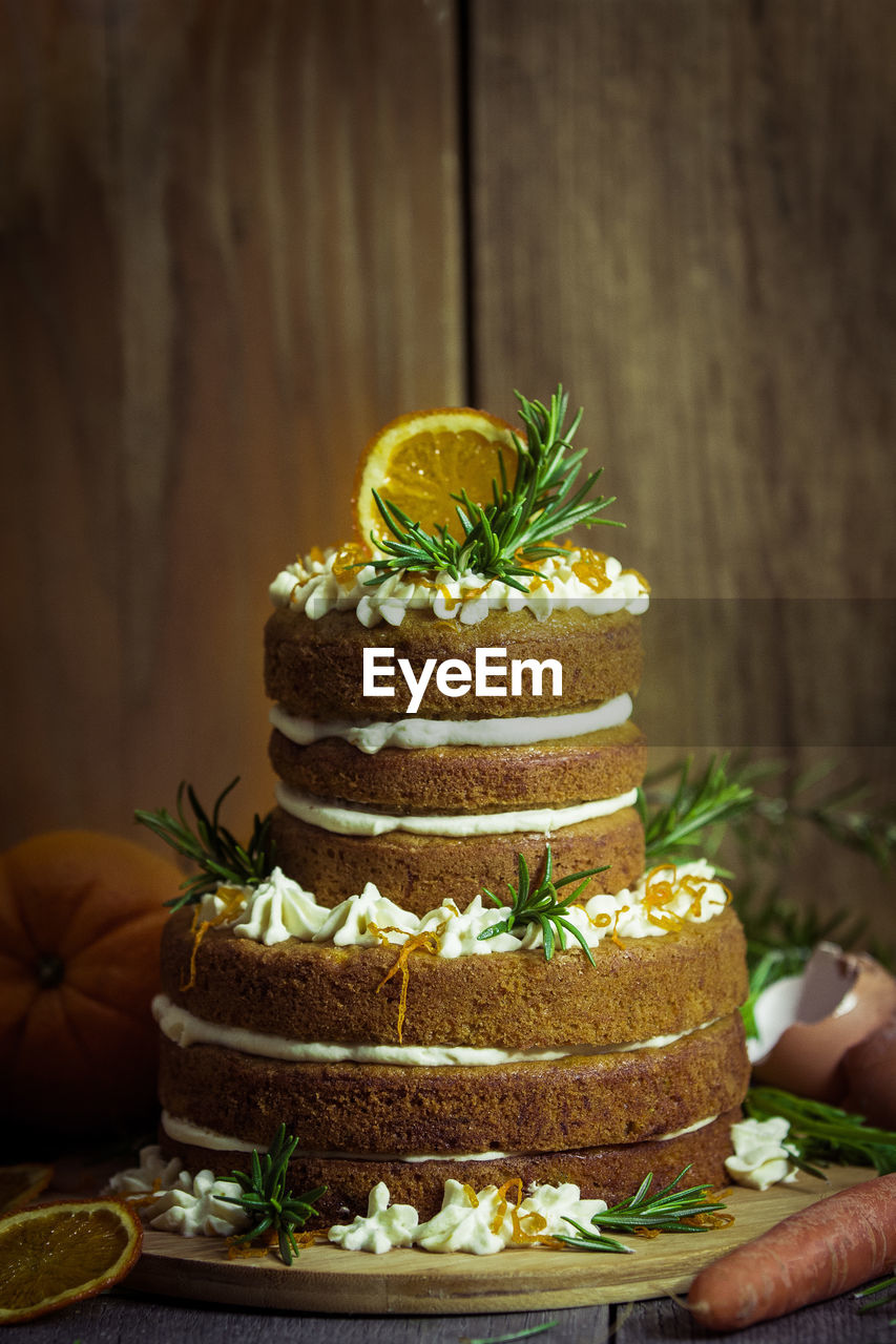 Cake on wooden table against wall